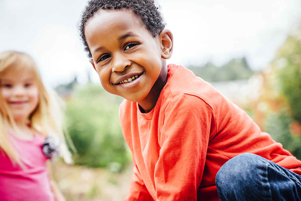 Portrait of smiling boy and girl outdoors