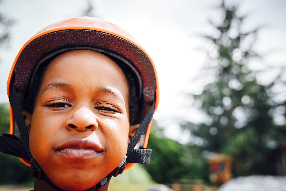 Sneering Black boy wearing helmet