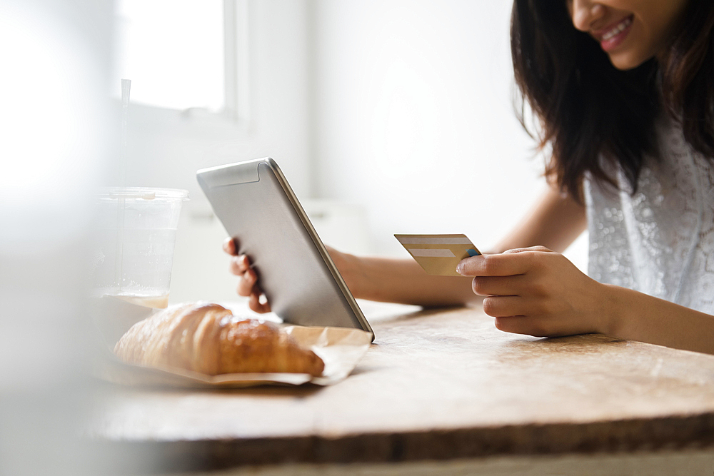 Mixed Race woman online shopping with credit card