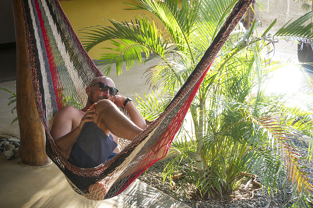 Caucasian man relaxing in hammock