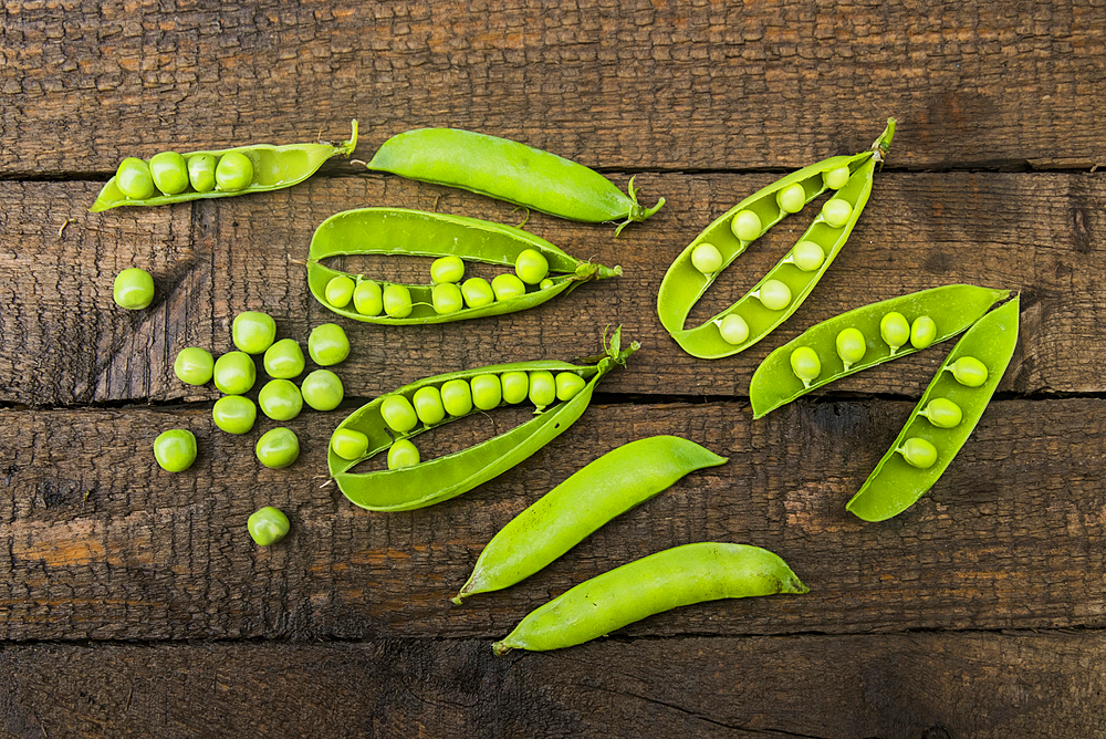 Fresh peas on wooden table