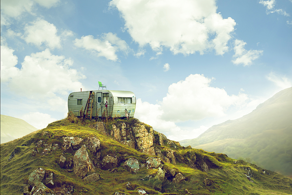 Motor home on hill in green landscape