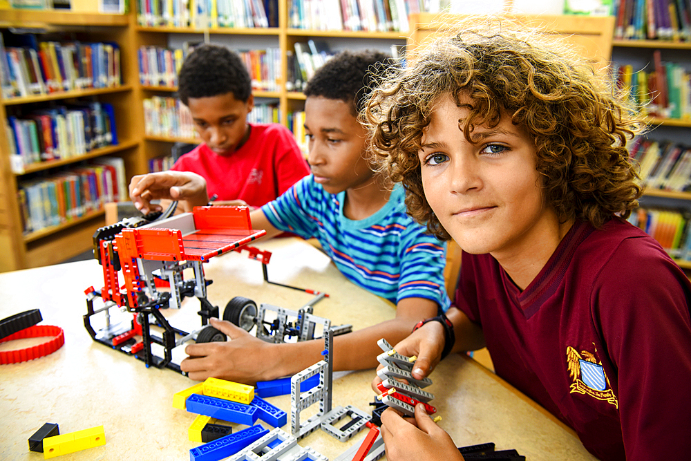 Boys assembling plastic blocks in library