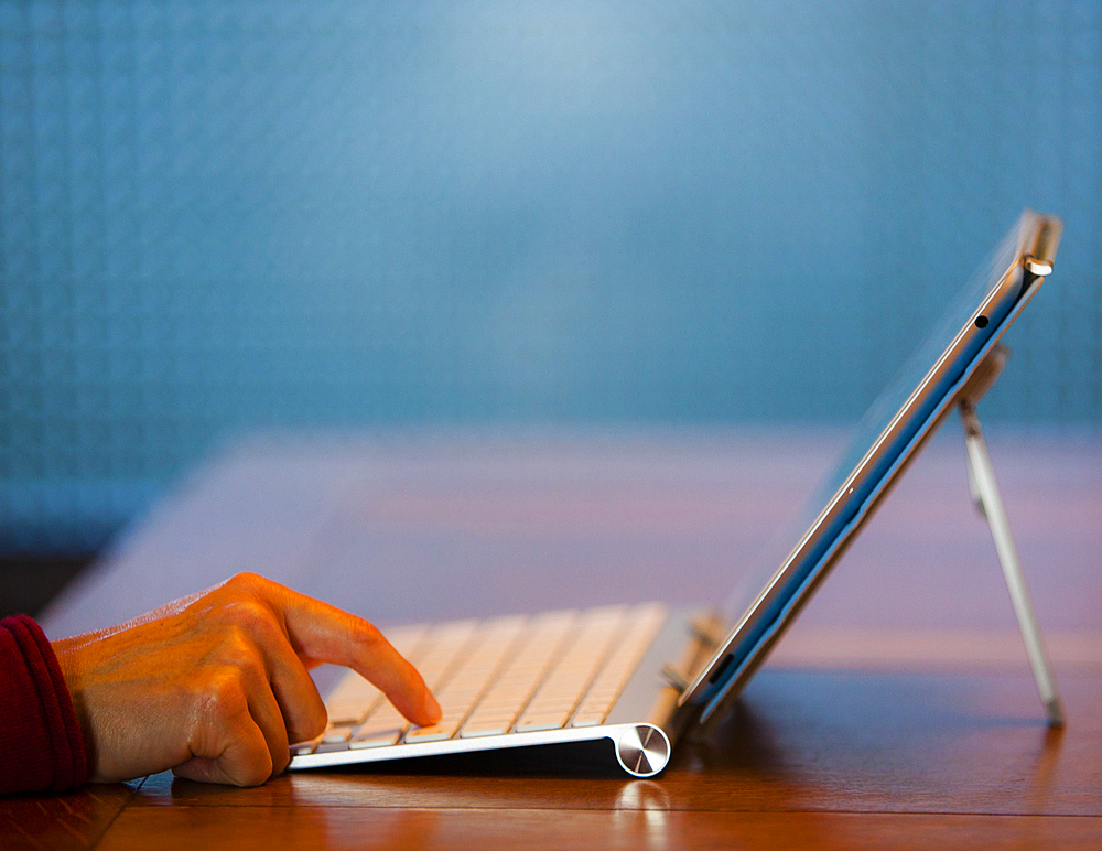 Finger of Japanese woman pressing keyboard for digital tablet