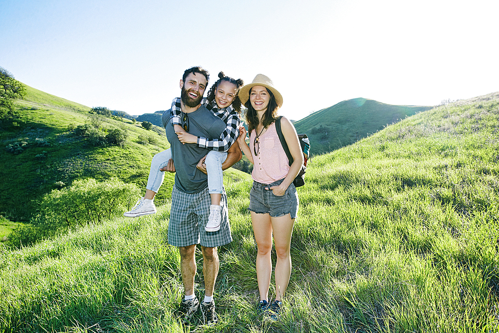 Portrait of happy family standing on hill