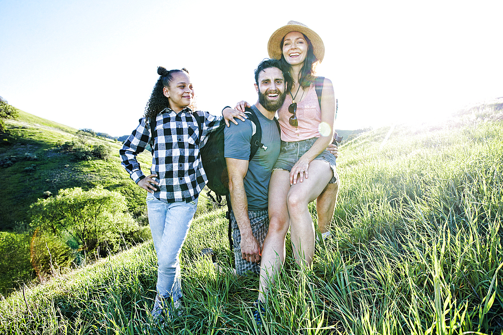 Portrait of smiling family posing on hill