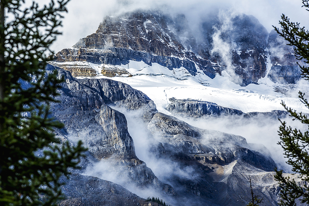 Fog on snowy mountain range