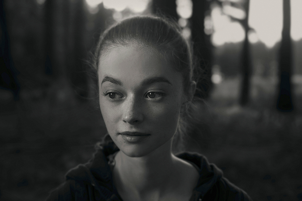 Portrait of Caucasian girl with freckles in forest