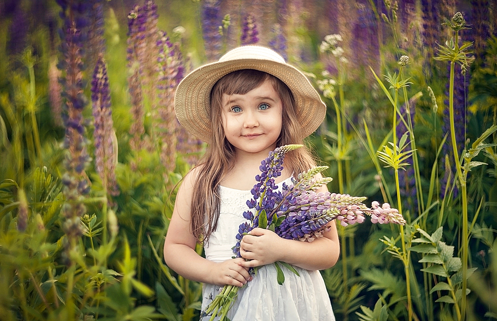 Caucasian girl holding bouquet of wildflowers