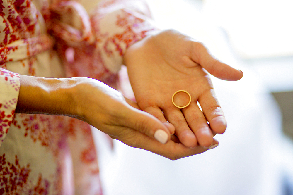 Caucasian woman holding wedding ring