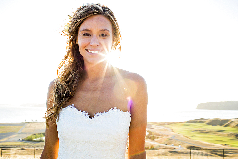 Caucasian bride smiling on sunny day