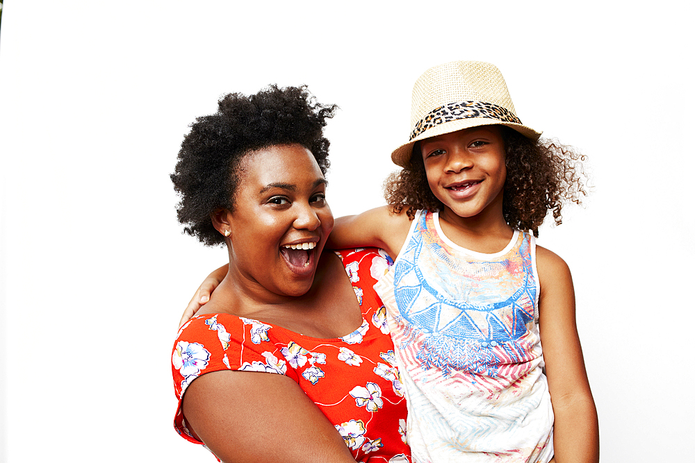 Portrait of smiling mother holding daughter