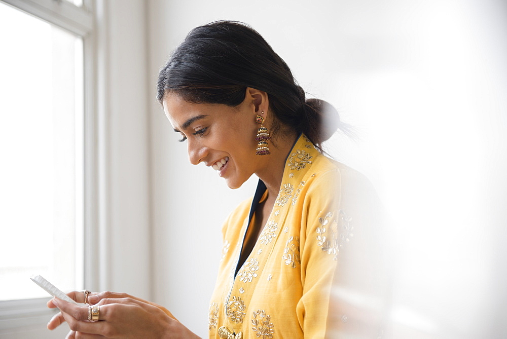 Indian woman texting with cell phone