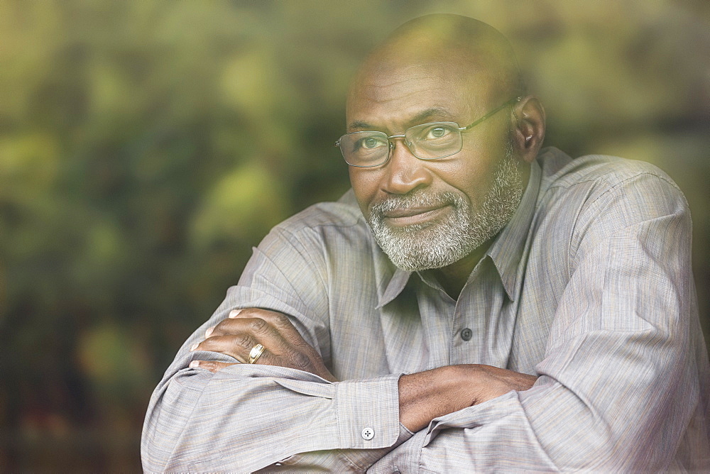 Pensive Black man behind window