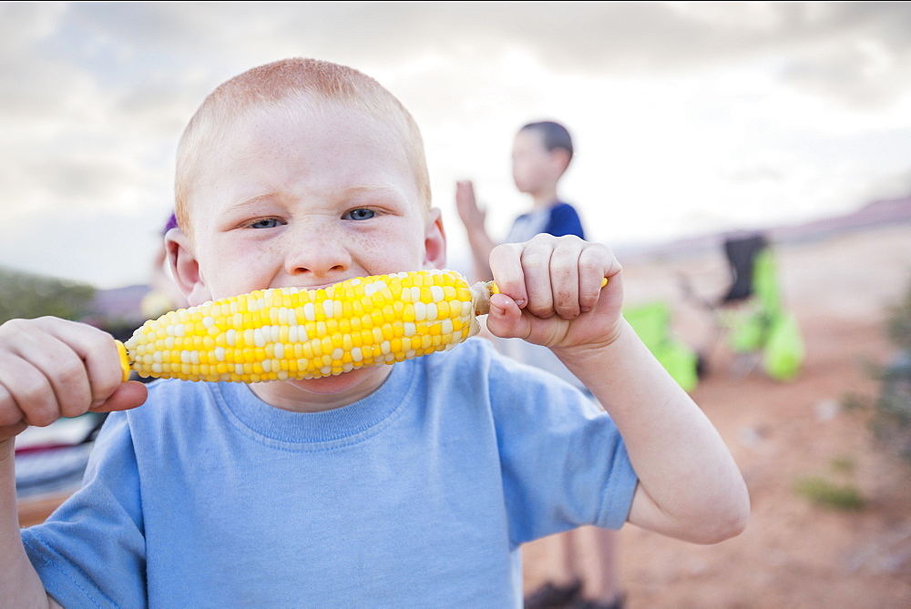 Caucasian boy eating corn on the cob