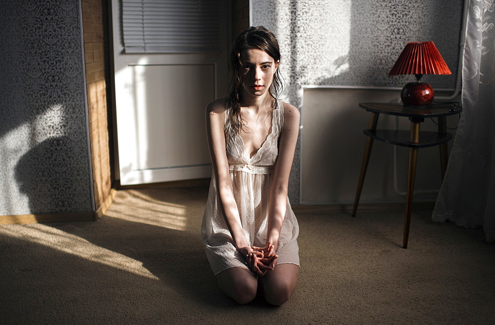 Caucasian woman kneeling on floor