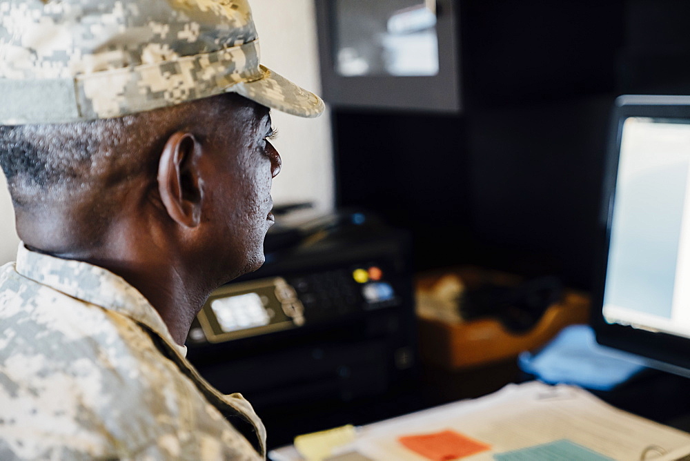 Black soldier using computer