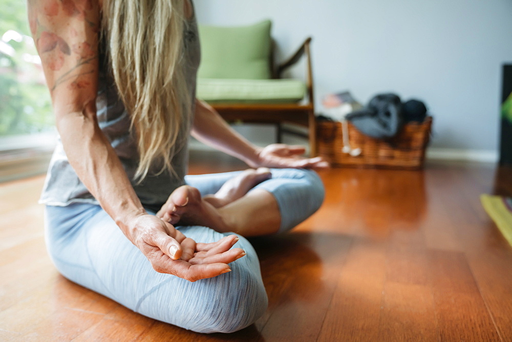 Caucasian woman meditating on floor