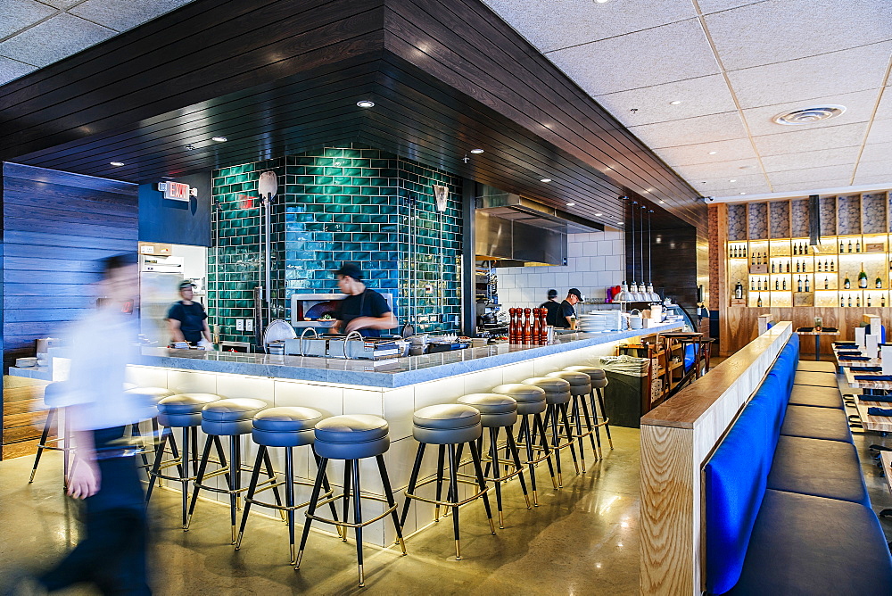 Busy Caucasian workers at counter in modern bar and restaurant