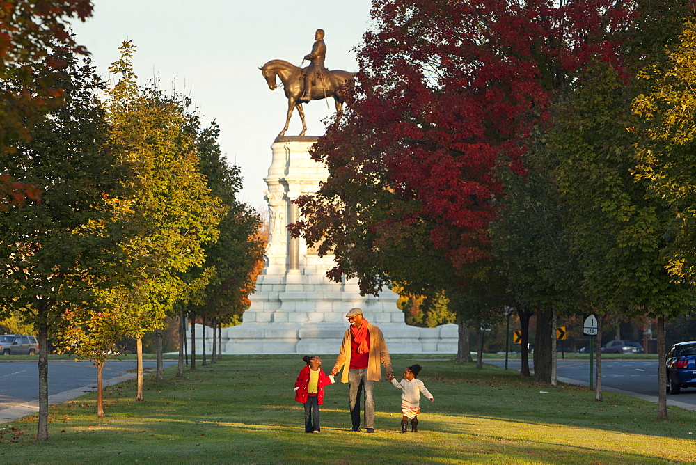 Father and daughters walking in park