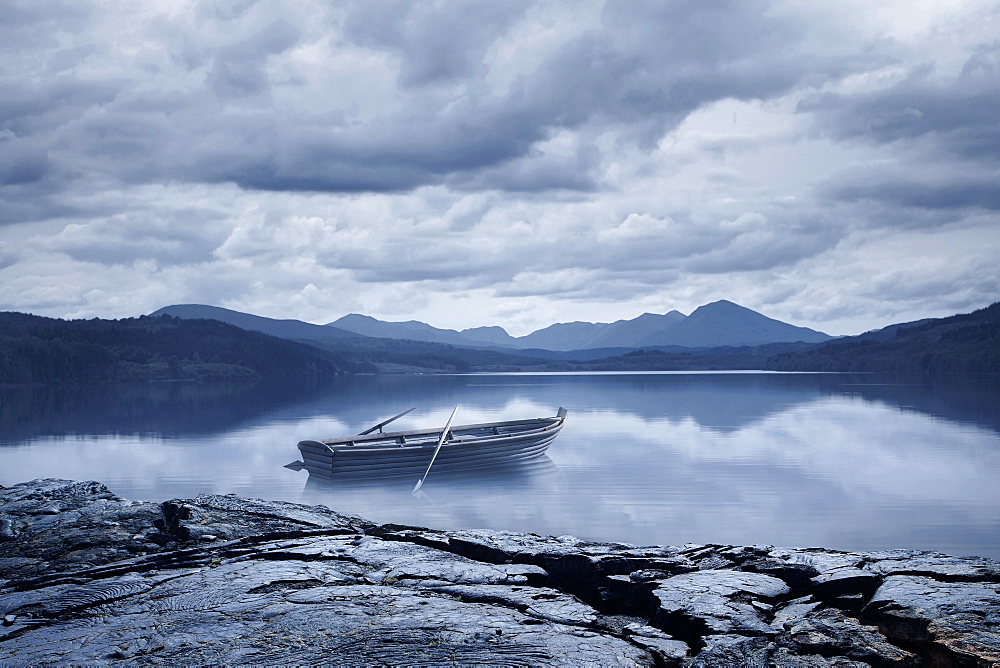 Abandoned rowboat in remote mountain lake