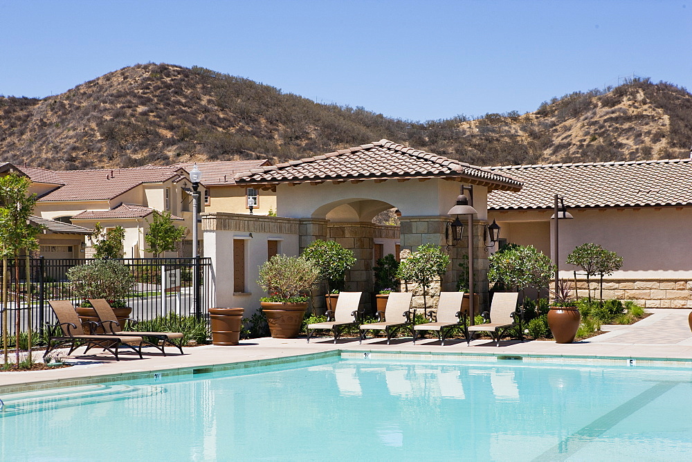 Outdoor swimming pool and deck chairs at community center