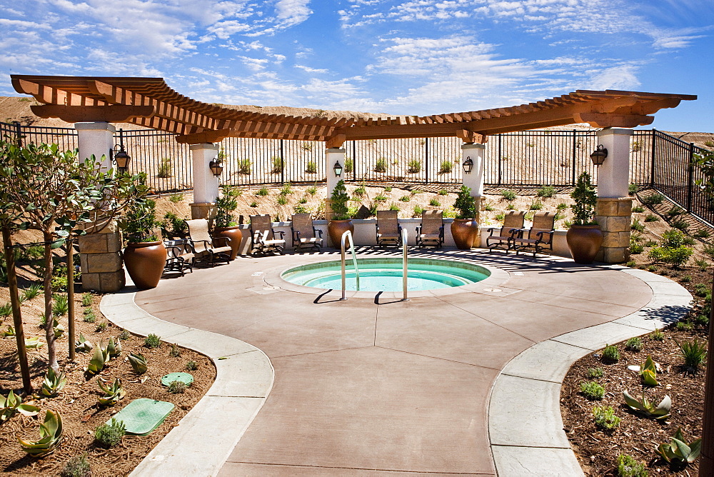 Chairs by small swimming pool