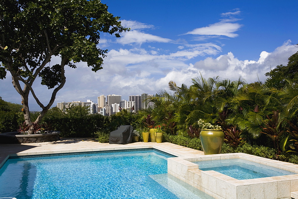 Outdoor swimming pool with view of downtown hawaiian city