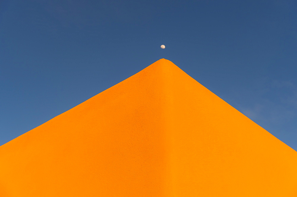 USA, New Mexico, Santa Fe, Moon over adobe pueblo building