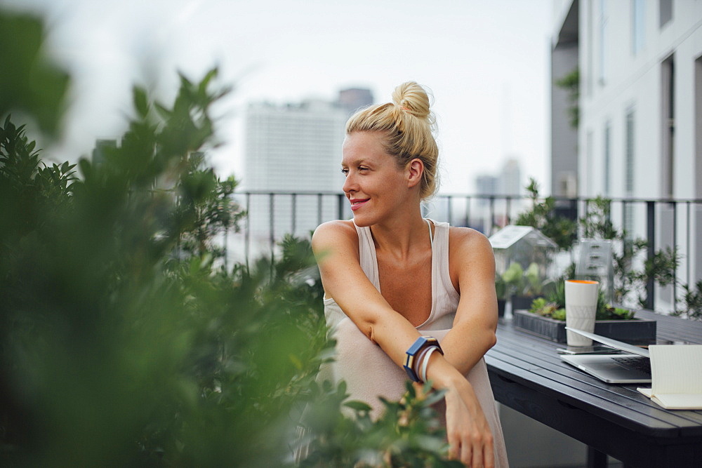 Caucasian woman sitting on balcony