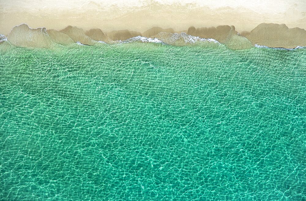 Overhead view of turquoise ocean and beach