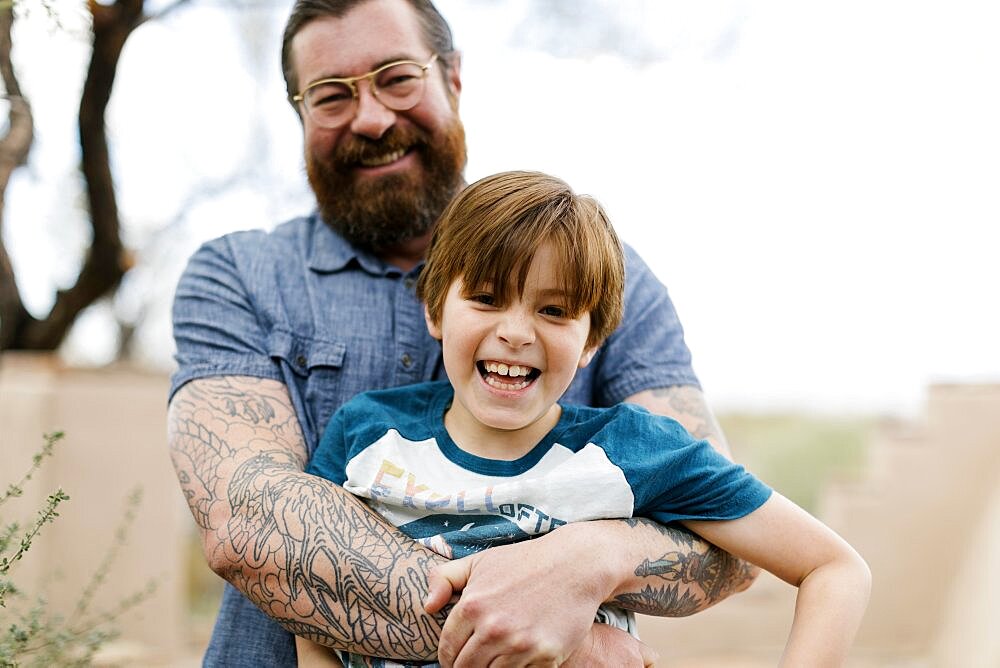 Father hugging son (8-9)