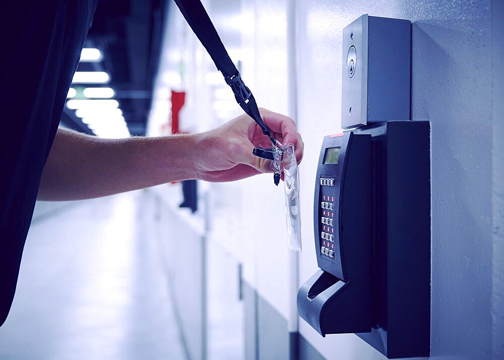 Close-up of employee using keycard and digital door lock in office