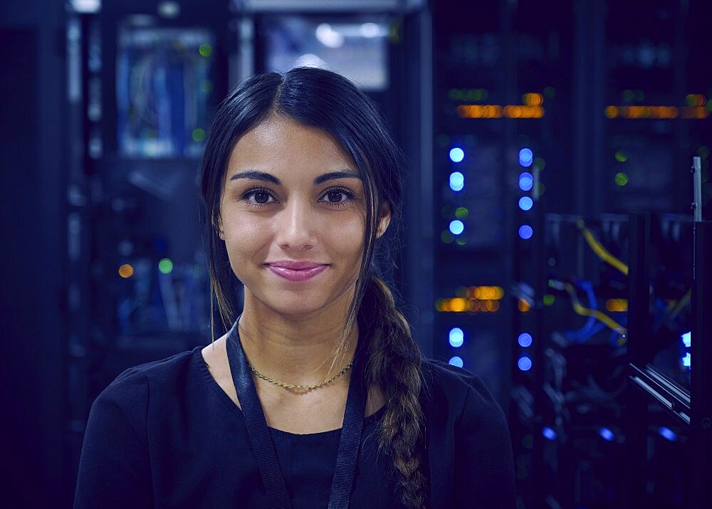 Portrait of smiling female technician in server room