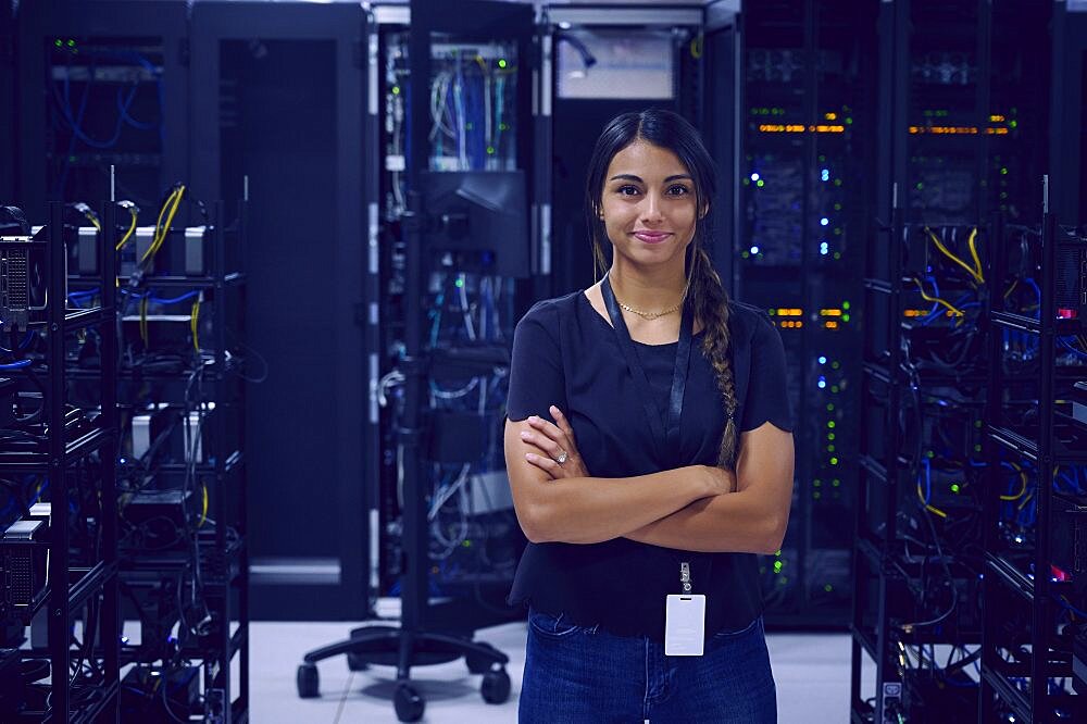 Portrait of smiling female technician in server room