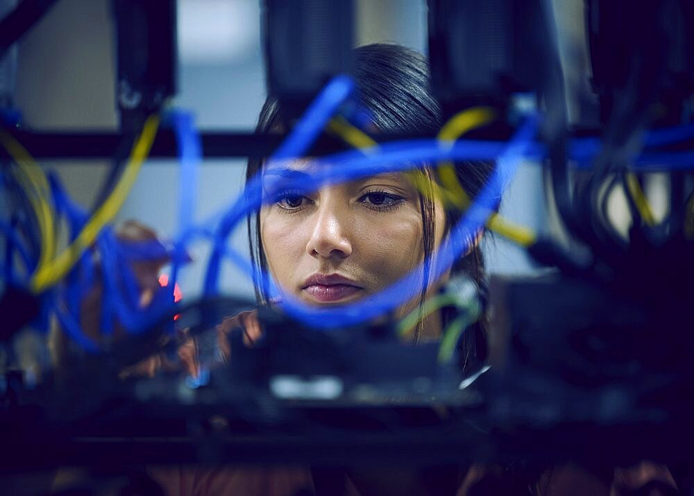 Close-up of female technician working in server room