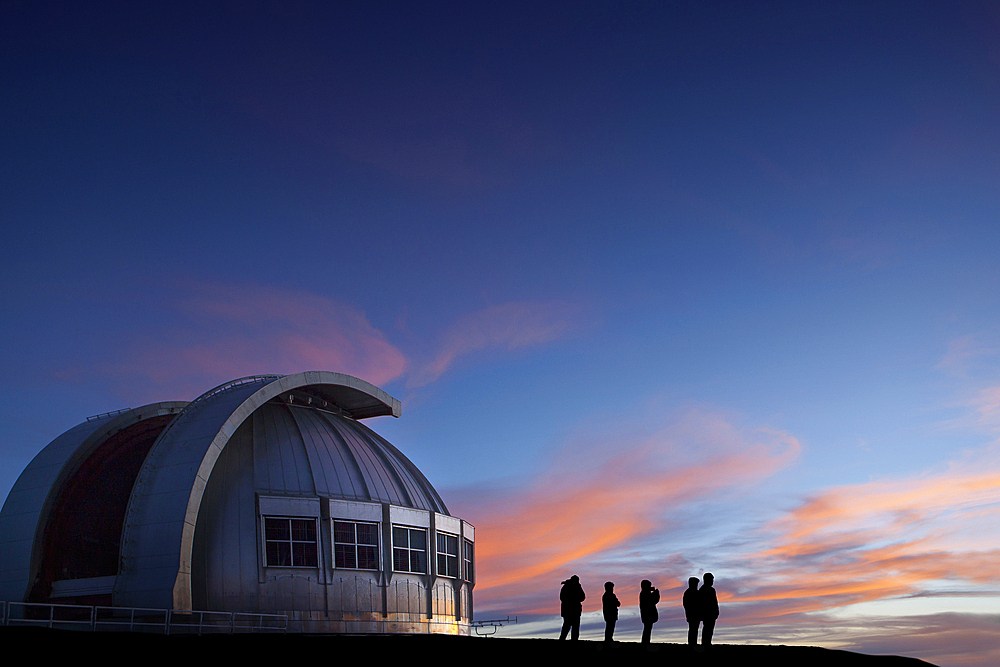 Silhouette of people watching sunset at observatory