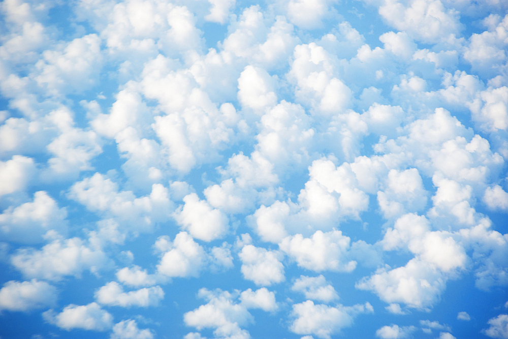 White cumulus clouds against blue sky