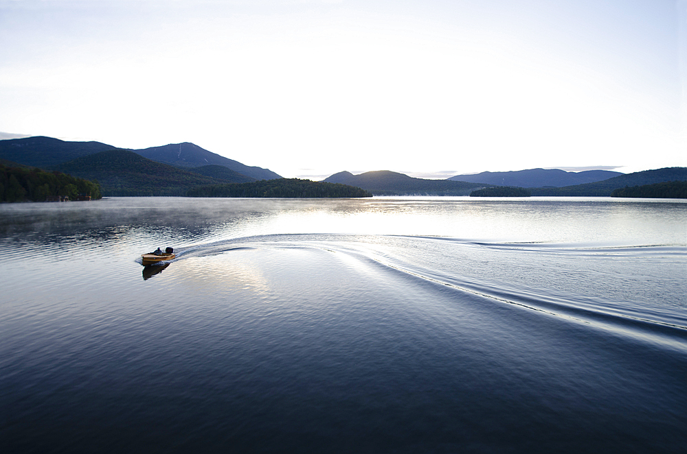 Boating at dawn on Lake Placid Lake, North Elba, New York, USA