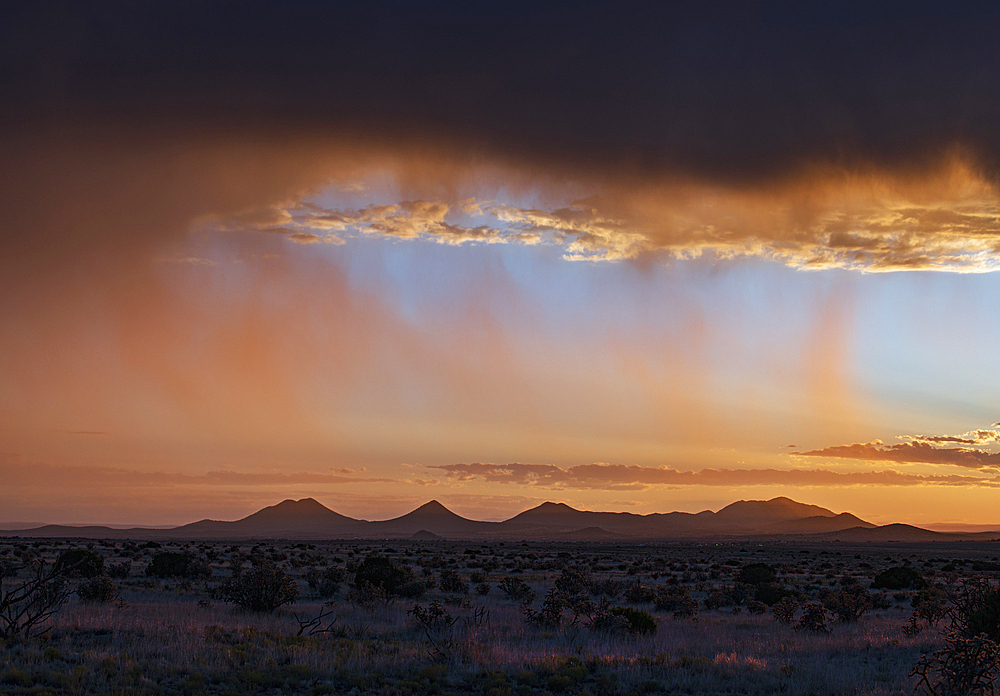 Usa, New Mexico, Santa Fe, Storm and rain over Cerrillos Hills at sunset