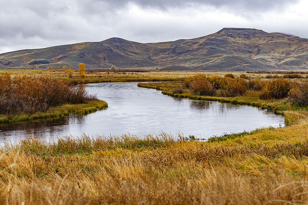 Quiet waters of Silver Creek with mountains in distance