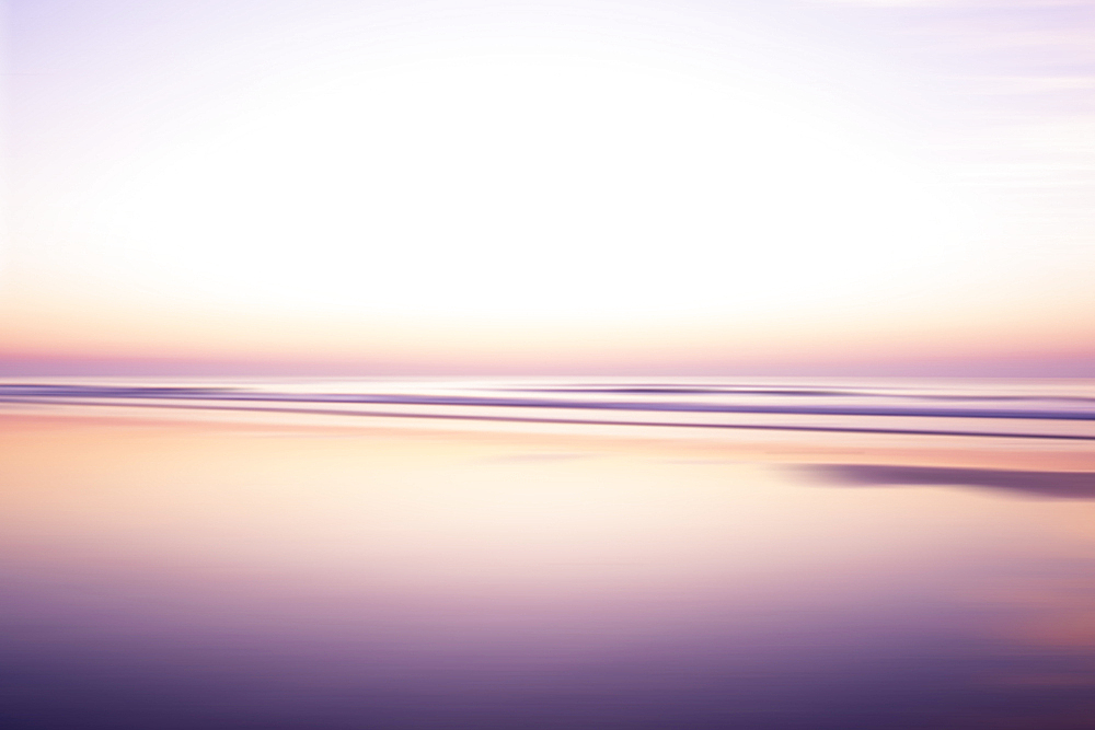 USA, New Jersey, Stone Harbor, Calm purple and orange water surface and sky at sunrise