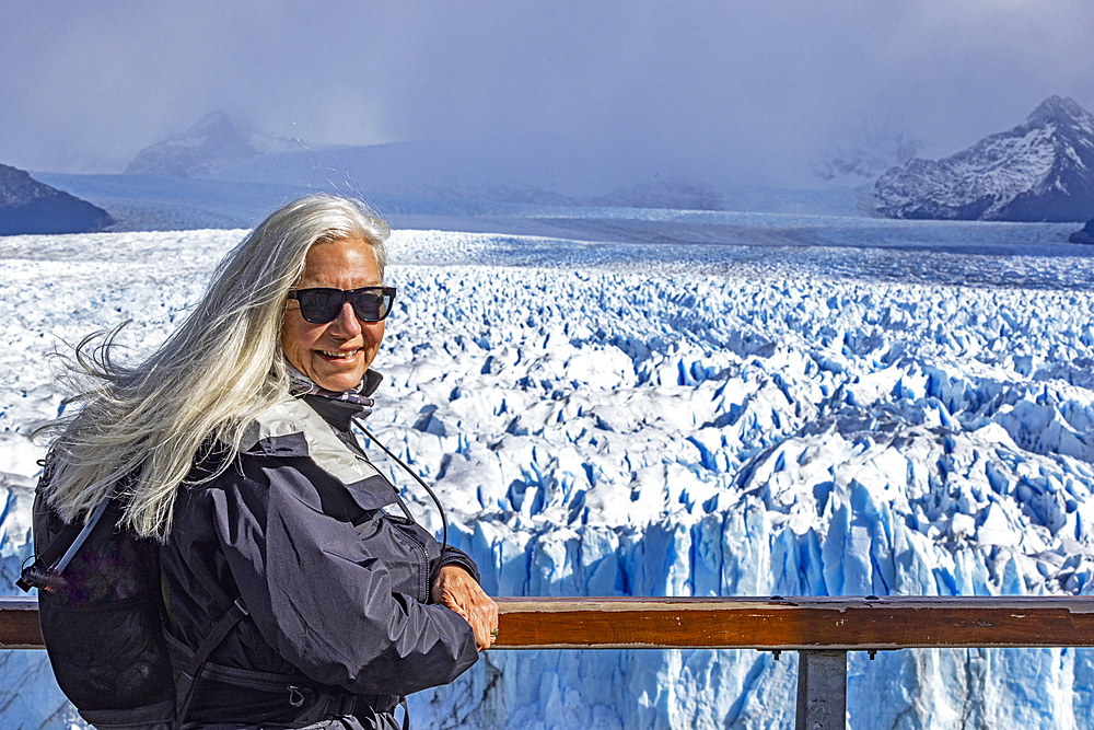 Argentina, Santa Cruz, El Calafate, Portrait of woman at Perito Moreno glacier ice formations