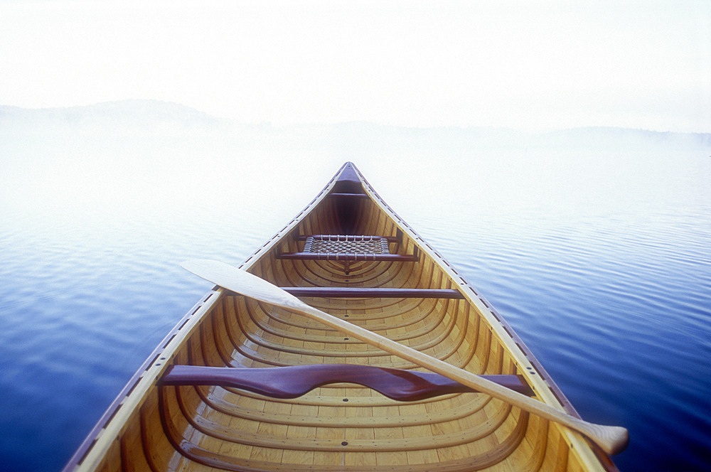 Wood canoe in morning mist on Saranac Lake
