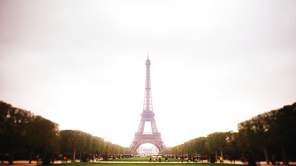 Parc Champ du Mars and the Eiffel Tower against cloudy sky