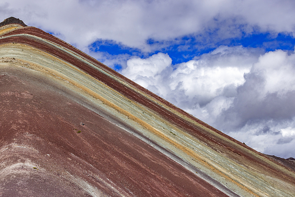 White puffy clouds over Rainbow Mountain
