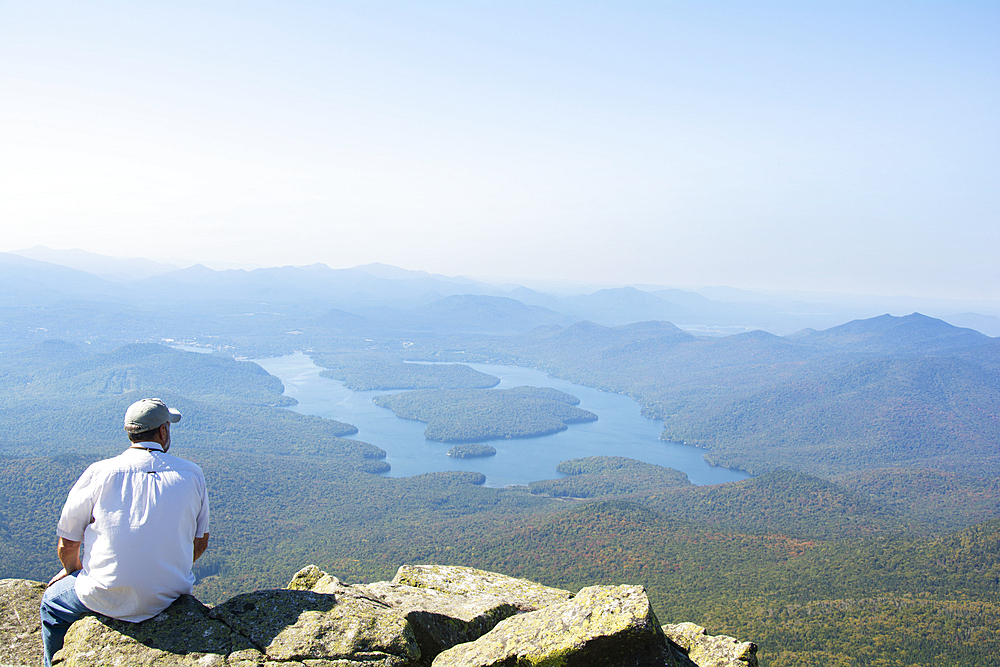 Rear view of man enjoying view of Lake Placid from Whiteface Mountain, Wilmington, New York State, USA
