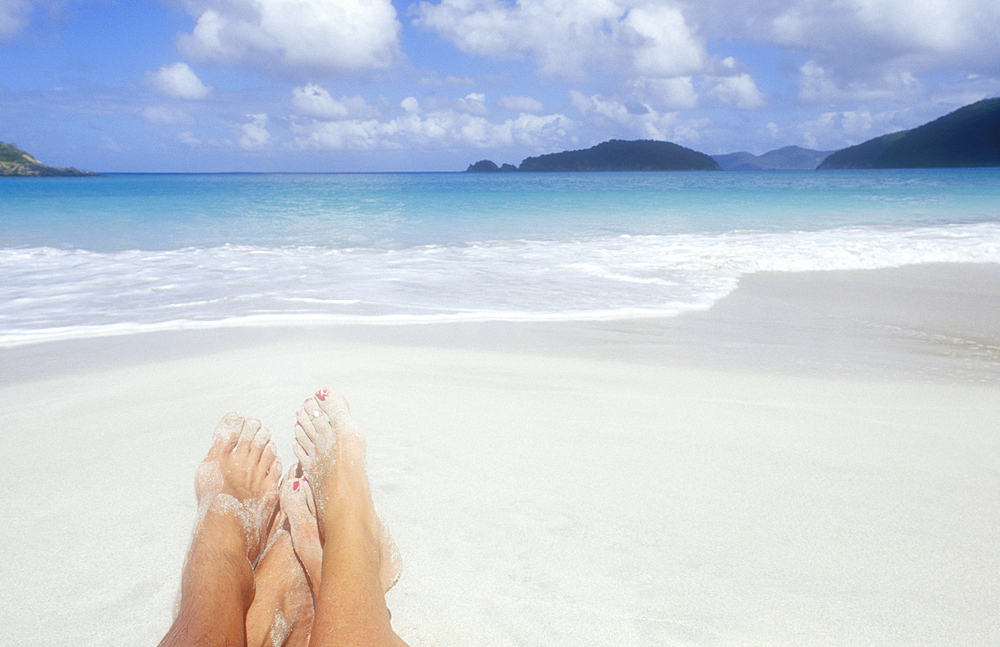 Couples bare feet on sandy beach, St. John, United States Virgin Islands, USA