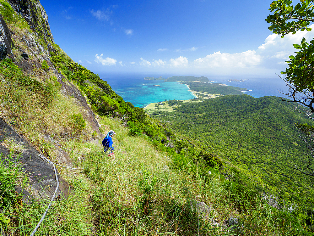 Woman hiking near Goathouse Cave on Lord Howe Island, Lord Howe Island, New South Wales, Australia