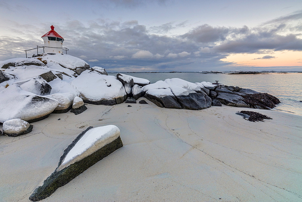 Colorful arctic sunset on the lighthouse surrounded by snow and icy sand, Eggum, Vestvagoy (Vest-Vagoy) Island, Lofoten Islands, Arctic, Norway, Scandinavia, Europe